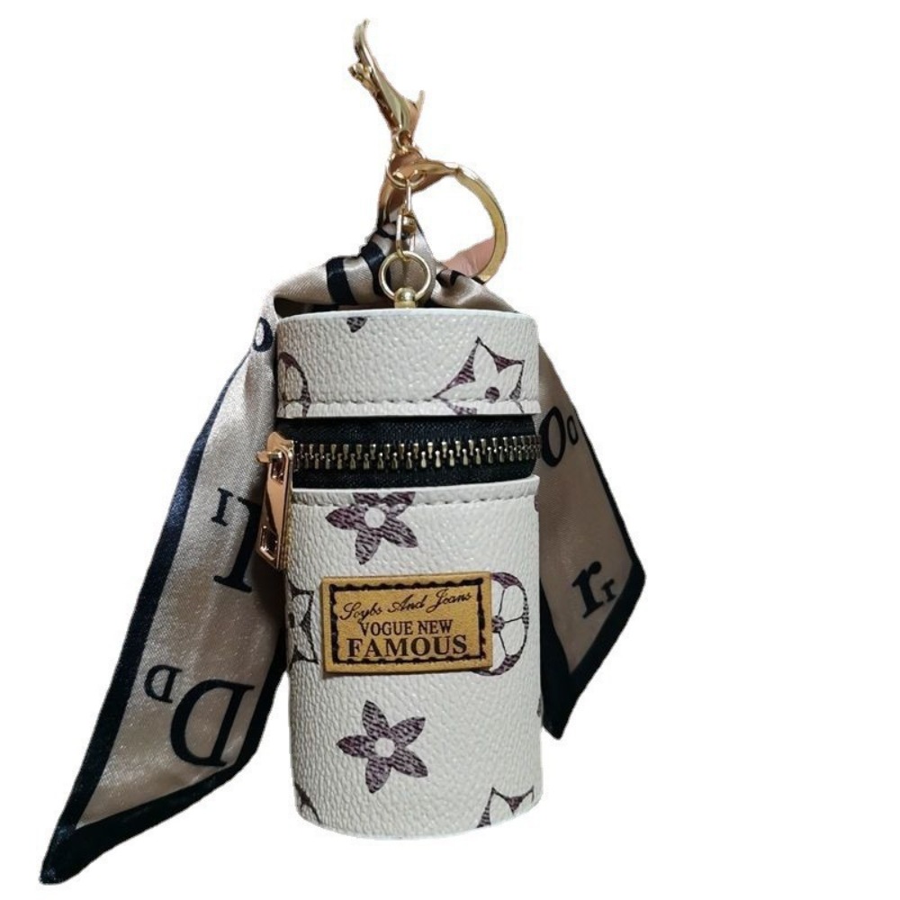 Monogram Keychain Leather - Off-White cilindrische mini-lippenstiftdoosje met bloemenmonogram, zwart-gouden